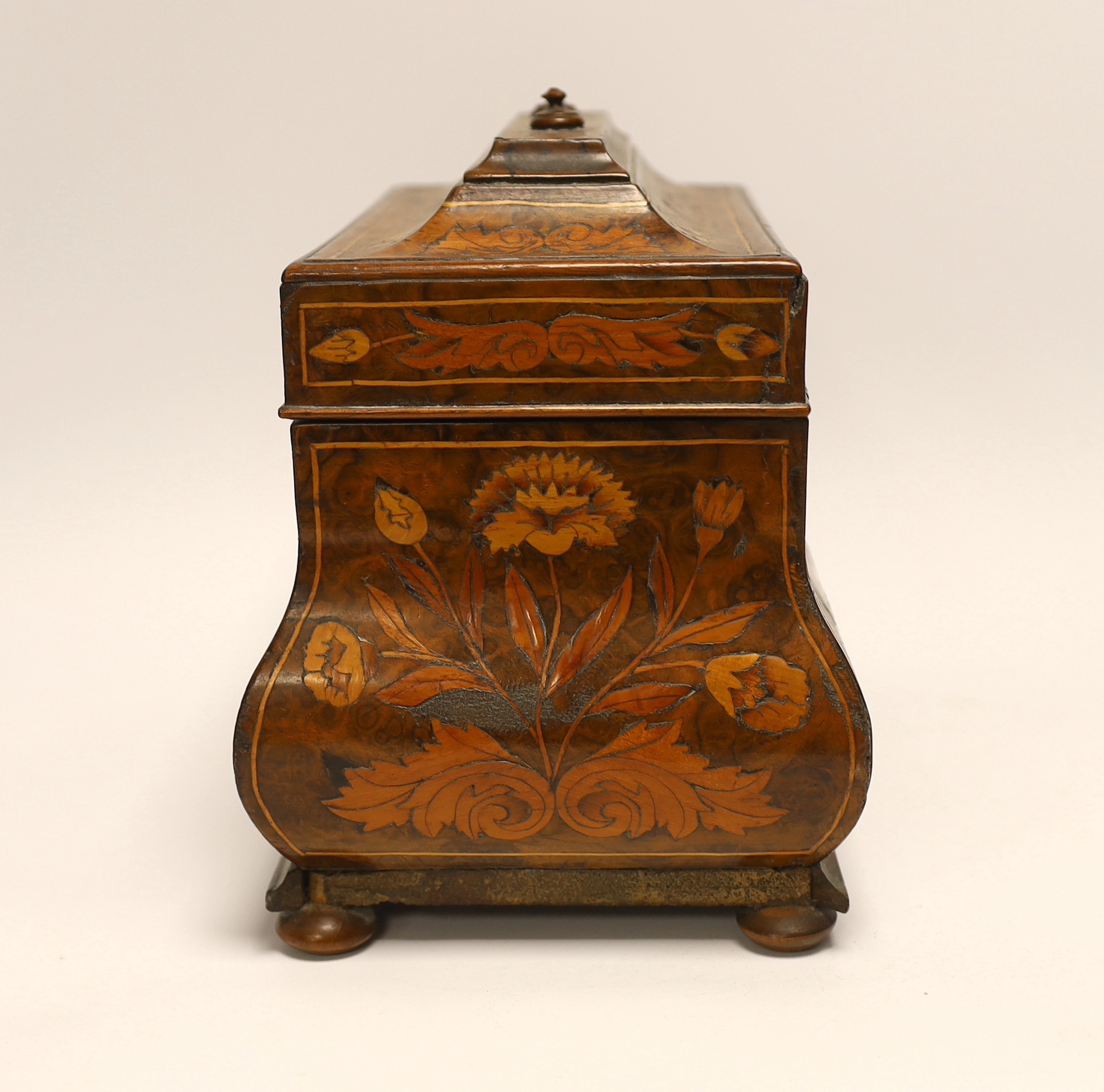 An 18th century Dutch floral marquetry bombé shaped tea caddy, 26cm wide